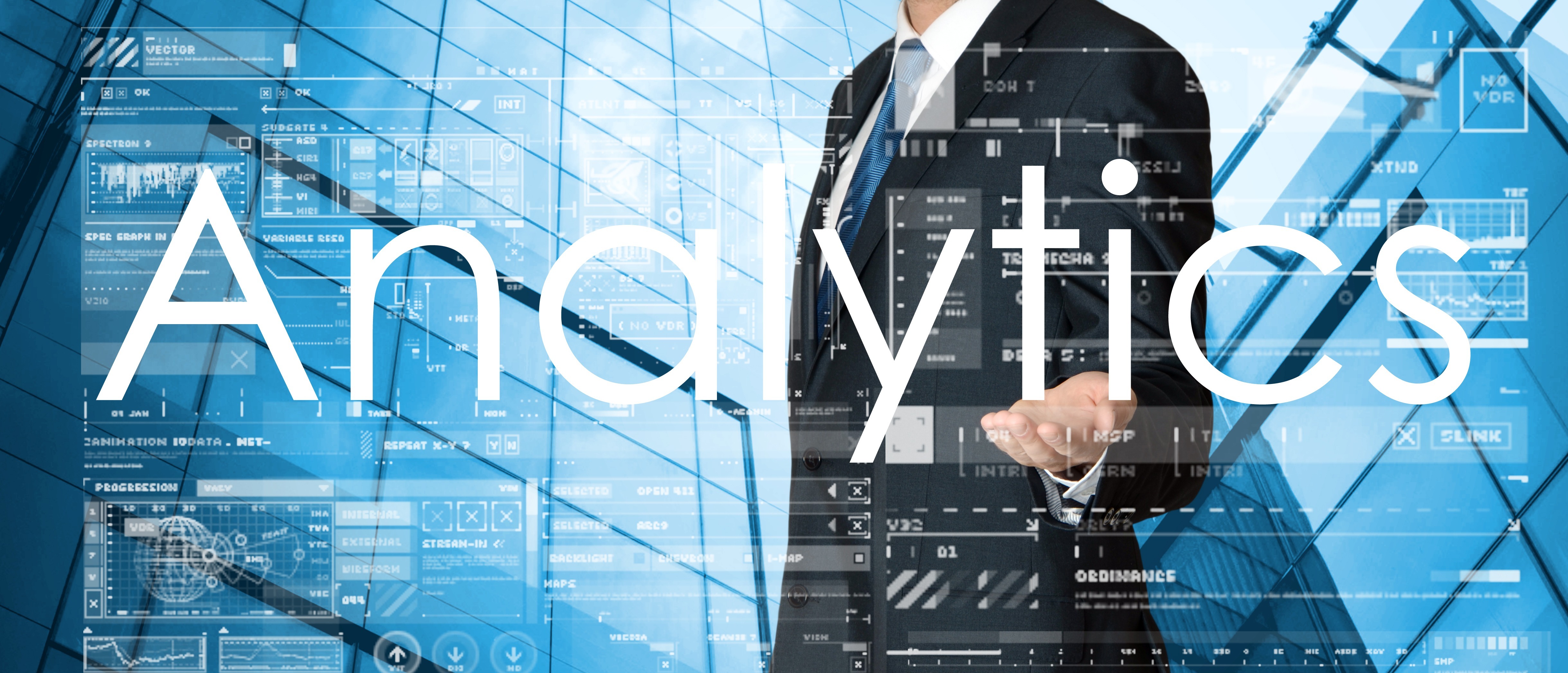 Image of a business professional in a suit gesturing amidst digital graphics and charts